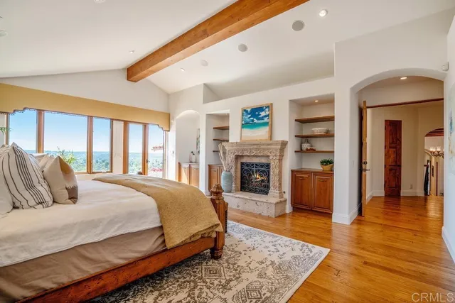 a spacious bedroom with a balcony a bed and a fireplace