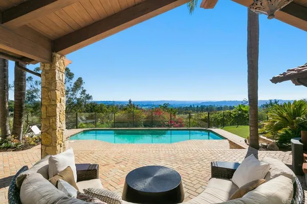 a view of a patio with couches under an umbrella