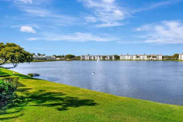 a view of a lake with houses in the back
