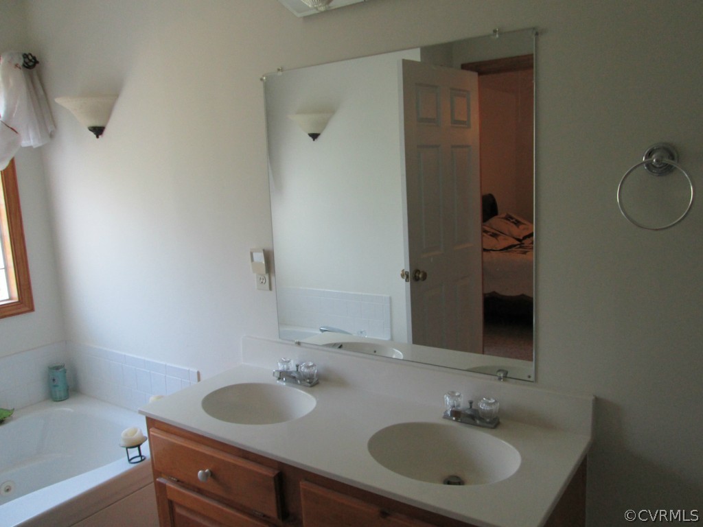 17755 Loving Union Road Disputanta, VA 23842 - Photo 17 of 20 a bathroom with a sink and a mirror