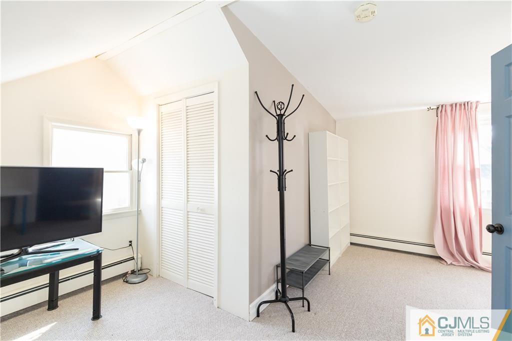 5 Mercury Road Edison, NJ 08817 - Photo 19 of 29 a view of a livingroom with furniture and a flat screen tv