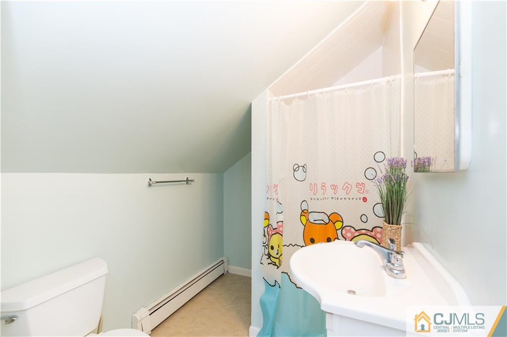 5 Mercury Road Edison, NJ 08817 - Photo 20 of 29 a bathroom with a sink a toilet and shower curtain