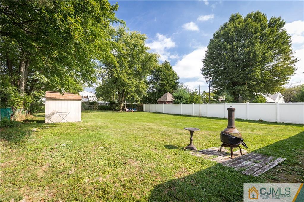 5 Mercury Road Edison, NJ 08817 - Photo 21 of 29 a swimming pool with some trees in the background
