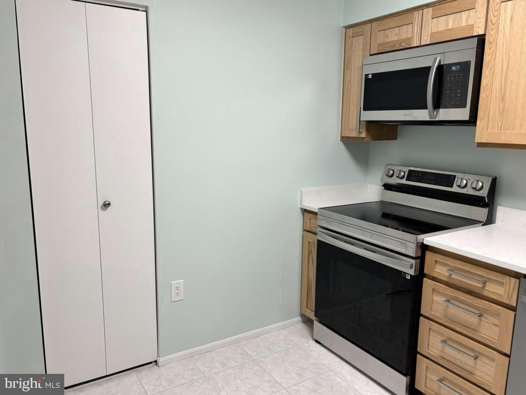 15115 Interlachen Drive, Unit 31020 Silver Spring, MD 20906 - Photo 14 of 48 a kitchen with a stove microwave and sink
