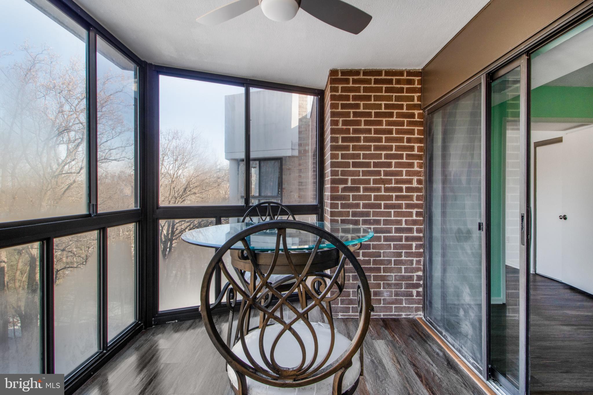 15115 Interlachen Drive, Unit 31020 Silver Spring, MD 20906 - Photo 21 of 48 a view of a porch with a table and chairs
