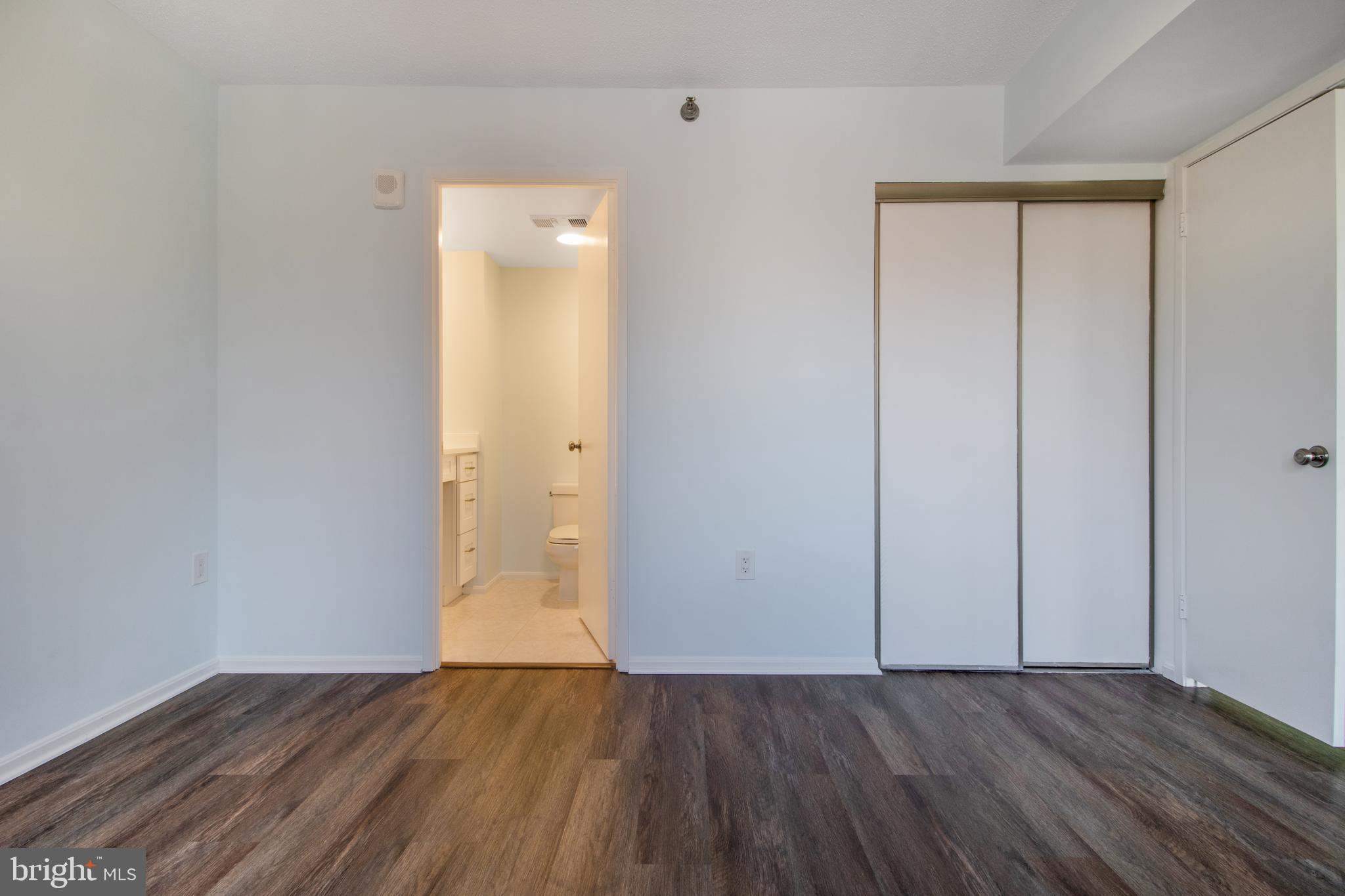 15115 Interlachen Drive, Unit 31020 Silver Spring, MD 20906 - Photo 22 of 48 an empty room with wooden floor and closet