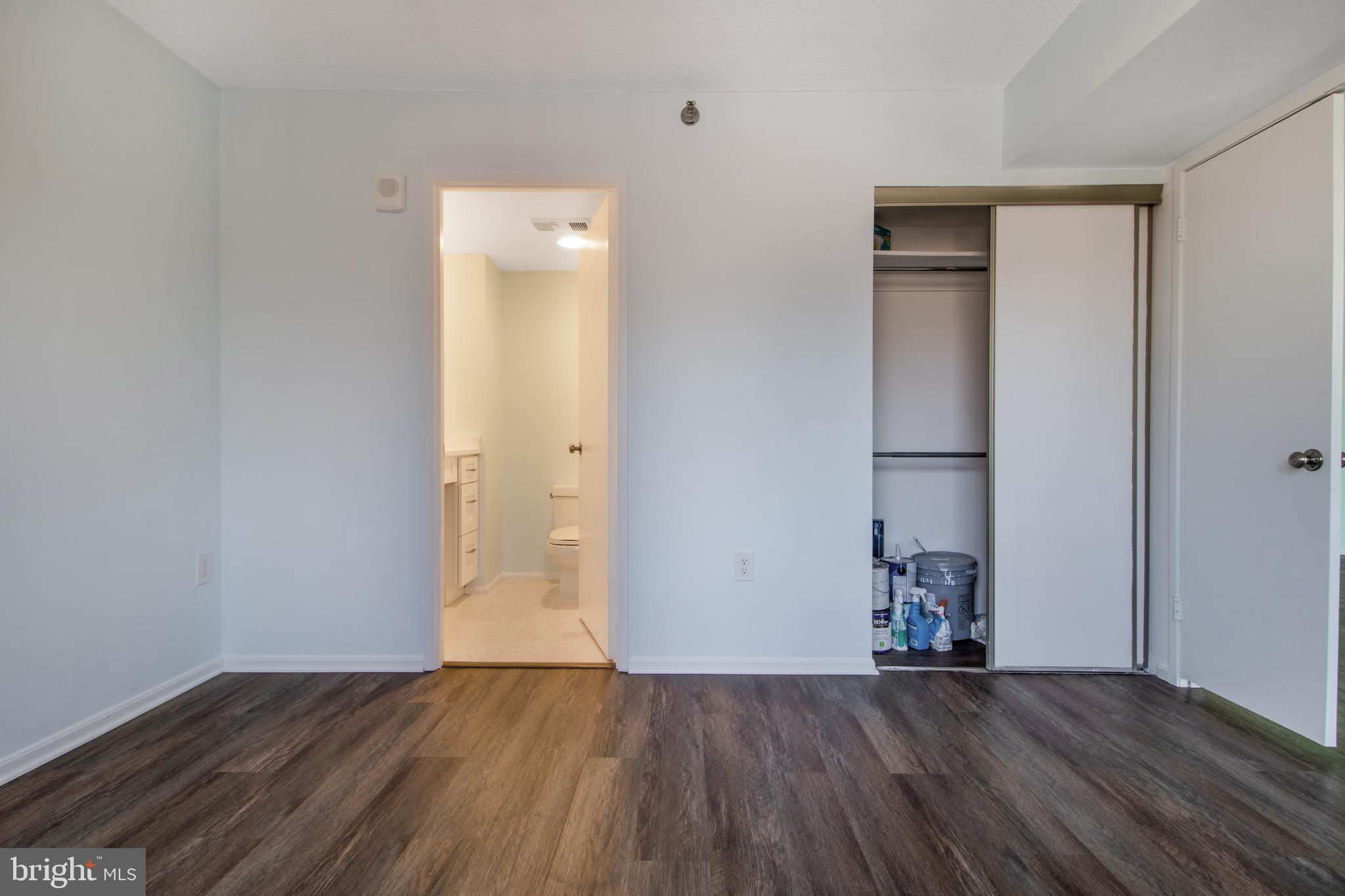 15115 Interlachen Drive, Unit 31020 Silver Spring, MD 20906 - Photo 23 of 48 an empty room with wooden floor and closet