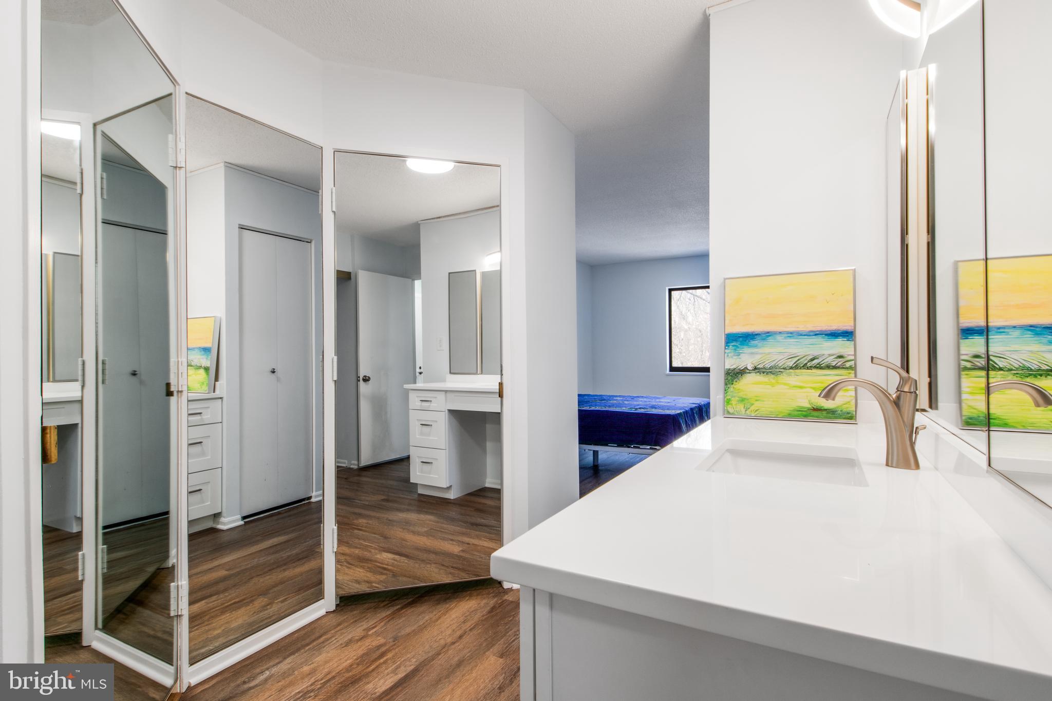 15115 Interlachen Drive, Unit 31020 Silver Spring, MD 20906 - Photo 26 of 48 a room with a bed and a view of walk in closet