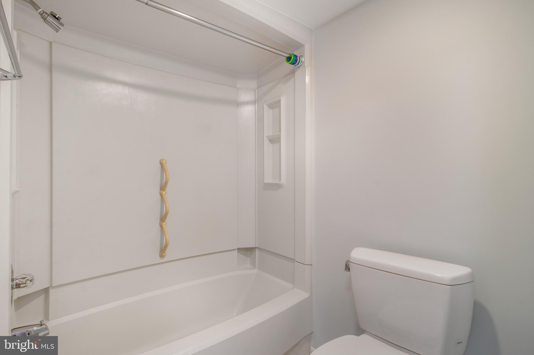 15115 Interlachen Drive, Unit 31020 Silver Spring, MD 20906 - Photo 30 of 48 a bathroom with a toilet and bathtub