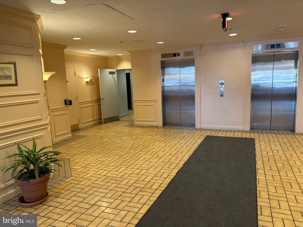 15115 Interlachen Drive, Unit 31020 Silver Spring, MD 20906 - Photo 3 of 48 a view of a hallway with a chandelier