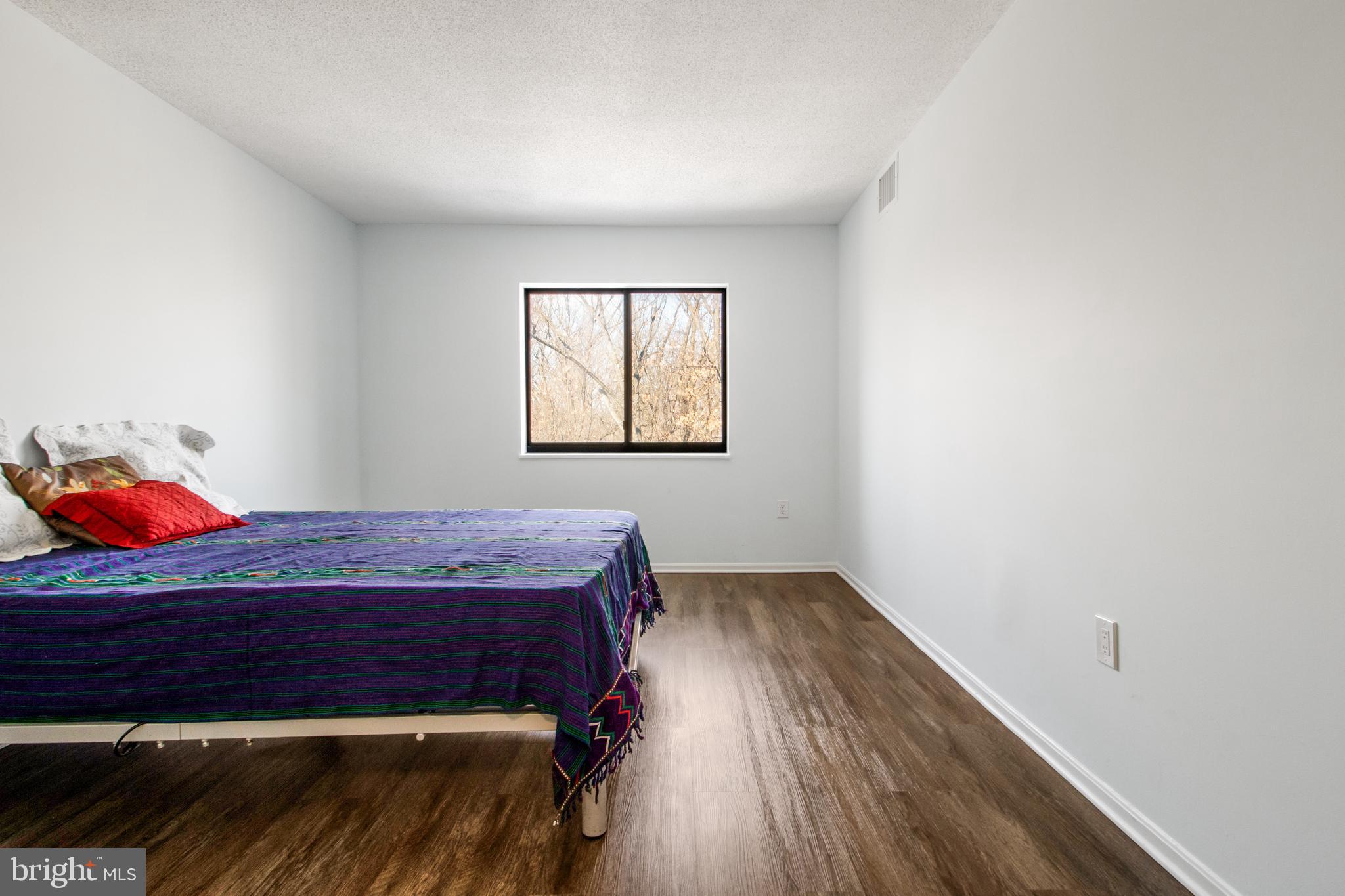 15115 Interlachen Drive, Unit 31020 Silver Spring, MD 20906 - Photo 33 of 48 a room with a bed and a window