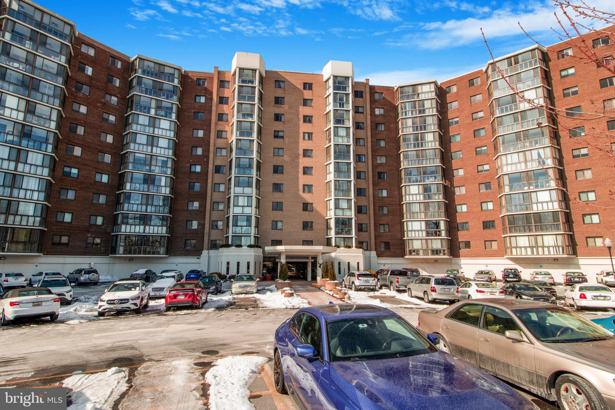 15115 Interlachen Drive, Unit 31020 Silver Spring, MD 20906 - Photo 40 of 48 a front view of a building with cars parked