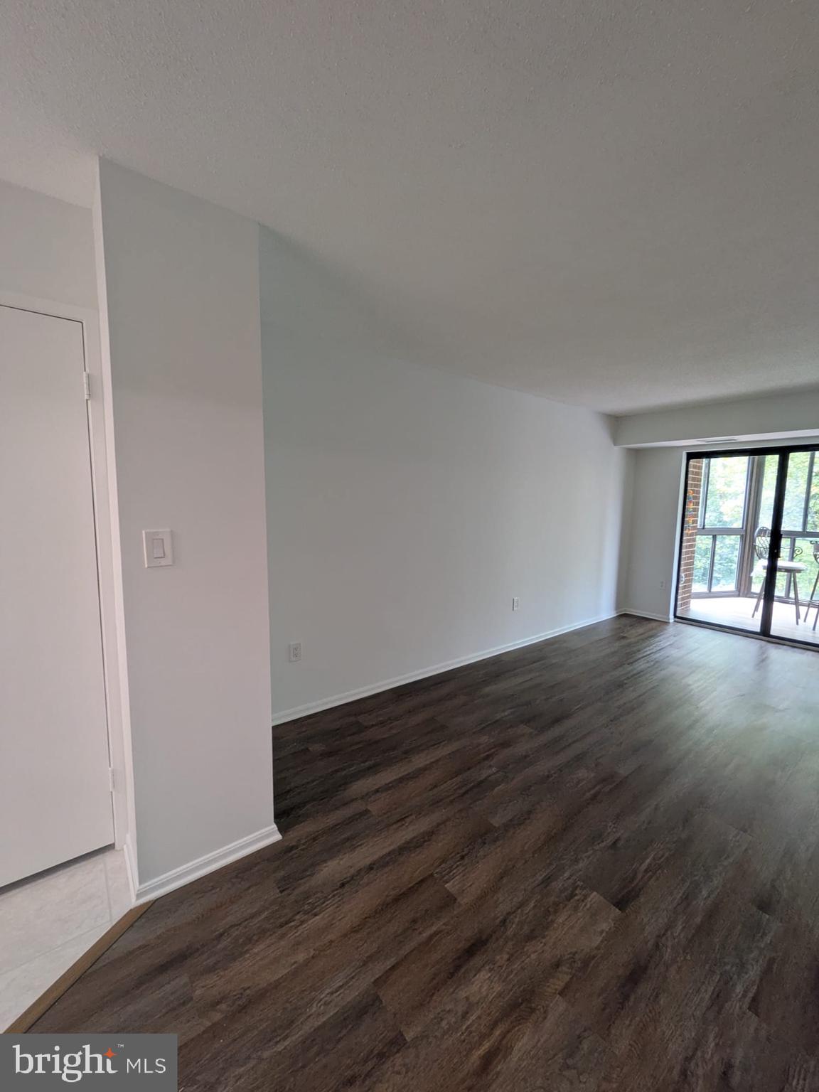 15115 Interlachen Drive, Unit 31020 Silver Spring, MD 20906 - Photo 47 of 48 a view of an empty room with wooden floor and a window