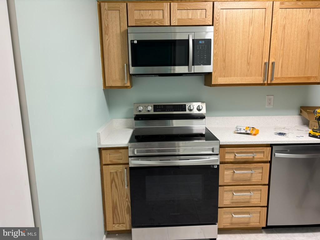 15115 Interlachen Drive, Unit 31020 Silver Spring, MD 20906 - Photo 8 of 48 a kitchen with a stove and a microwave
