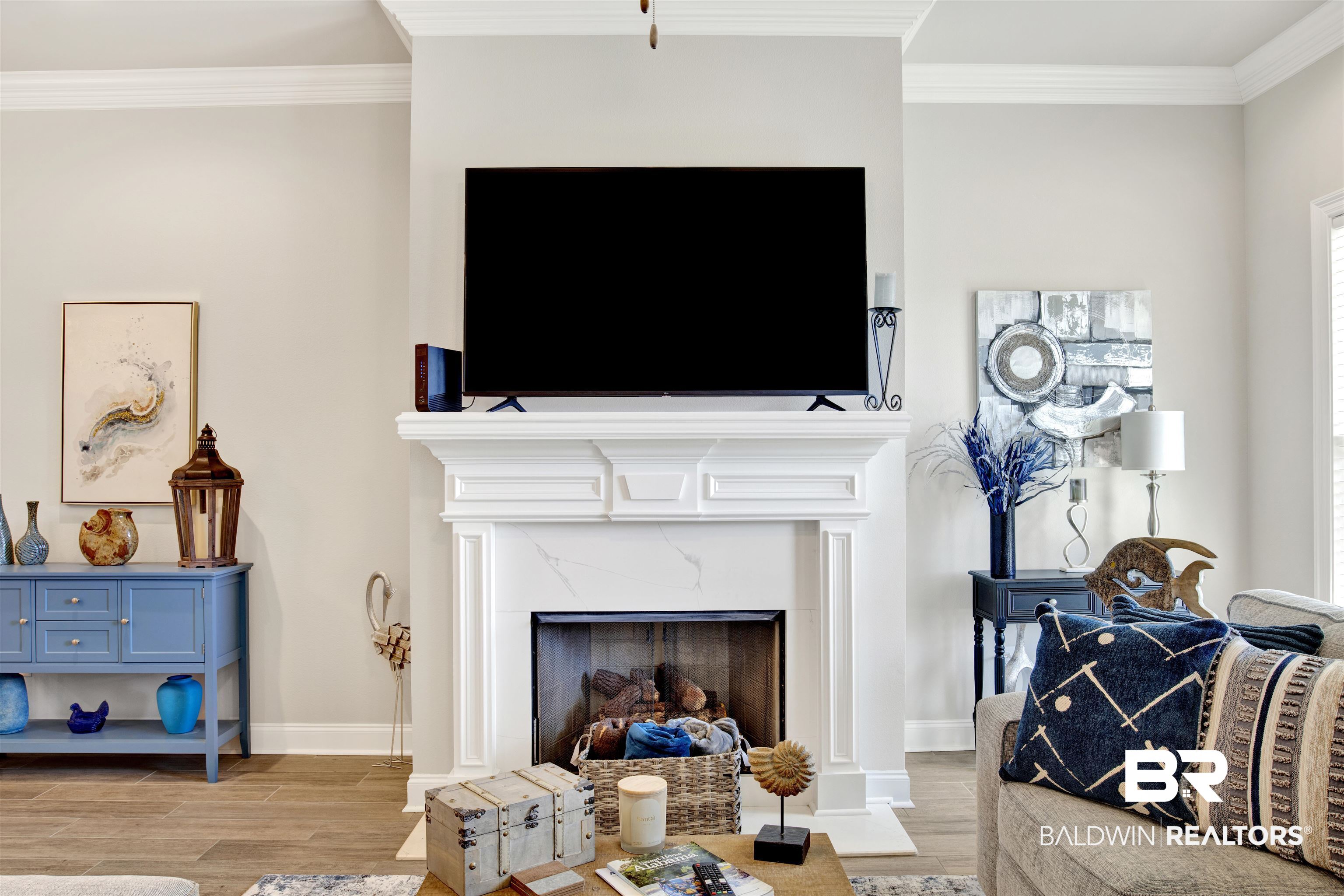 1406 Aldon Street Foley, AL 36535 - Photo 7 of 30 Living room featuring a premium fireplace, ornamental molding, and luxury wood-look tile flooring.