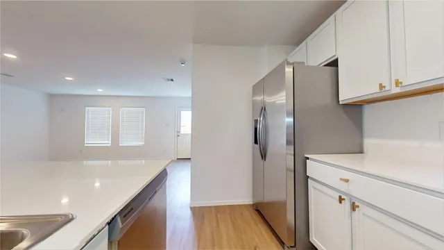 a kitchen with a sink and refrigerator