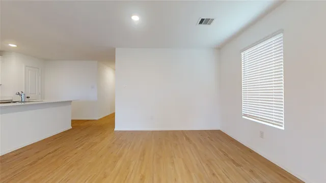 a view of a kitchen with wooden floor and a sink