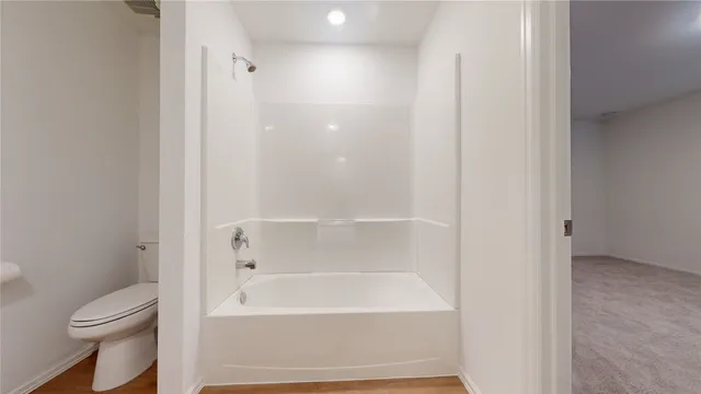 a bathroom with a bathtub and a toilet