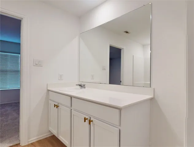 a room with a sink and mirror