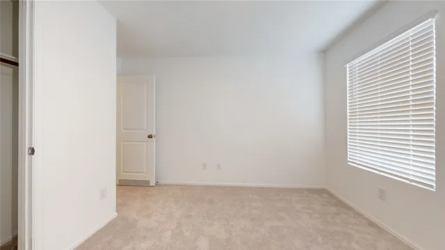 a view of an empty room and a window