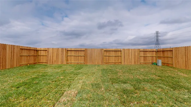 a view of a swimming pool with a yard in the background
