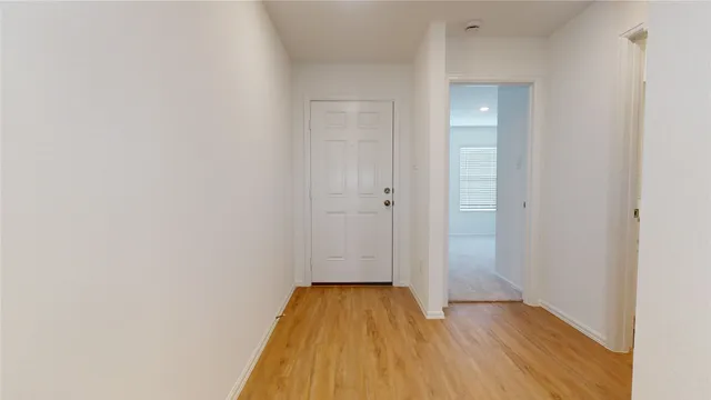 a view of a room with wooden floor and a gate