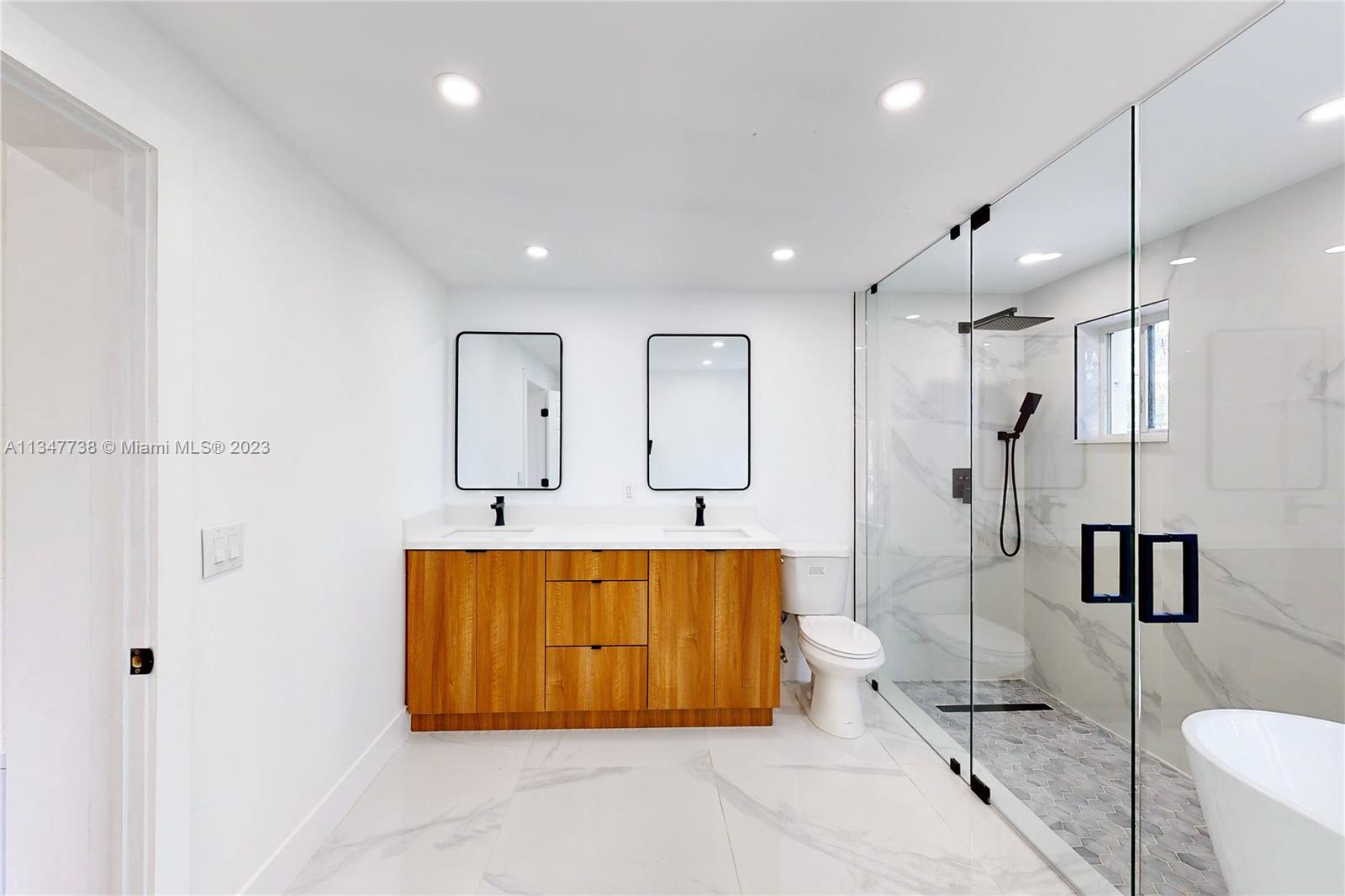 7950 Southwest 22nd Street Miami, FL 33155 - Photo 14 of 36 a bathroom with a tub and a shower