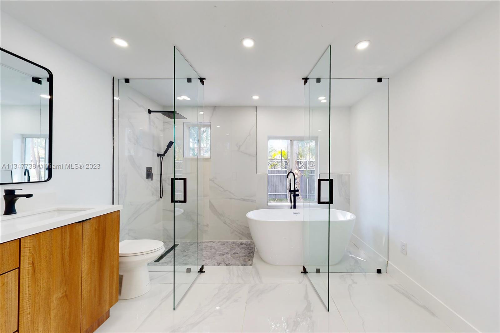 7950 Southwest 22nd Street Miami, FL 33155 - Photo 15 of 36 a bathroom with a sink a toilet and shower