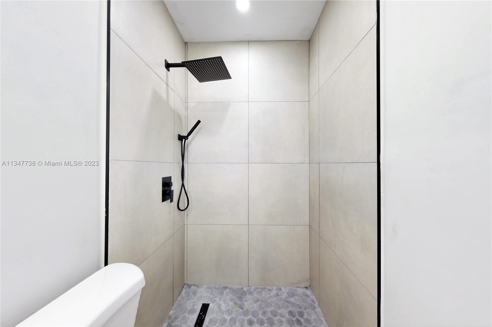 7950 Southwest 22nd Street Miami, FL 33155 - Photo 18 of 36 a bathroom with a toilet and shower