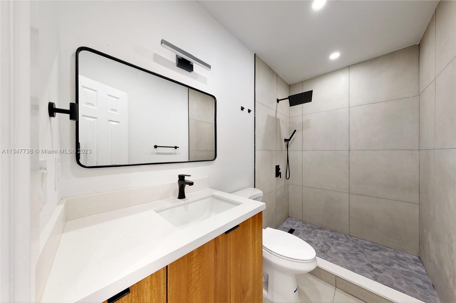7950 Southwest 22nd Street Miami, FL 33155 - Photo 21 of 36 a bathroom with a sink a toilet and shower
