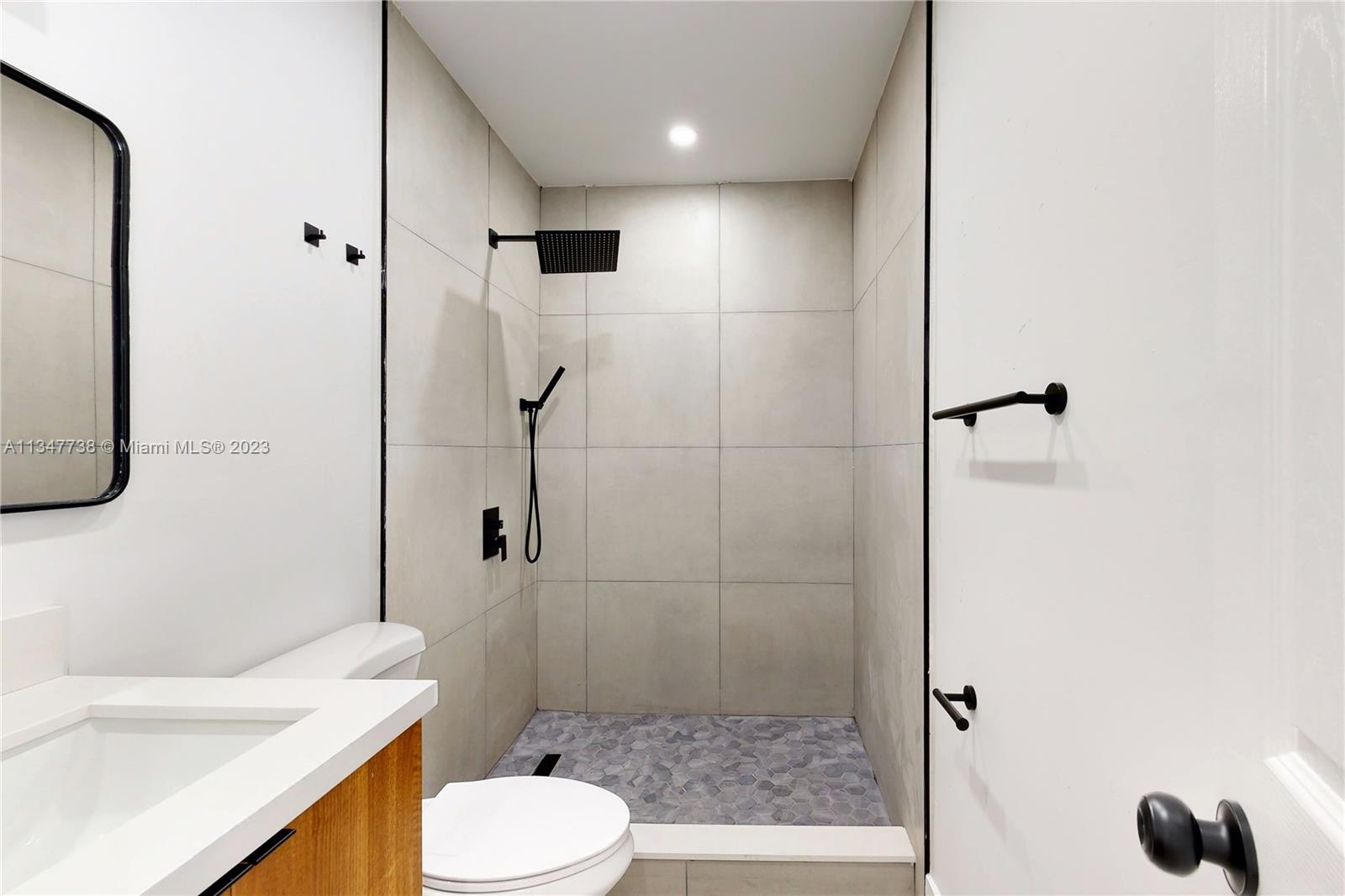 7950 Southwest 22nd Street Miami, FL 33155 - Photo 22 of 36 a bathroom with a sink toilet and shower