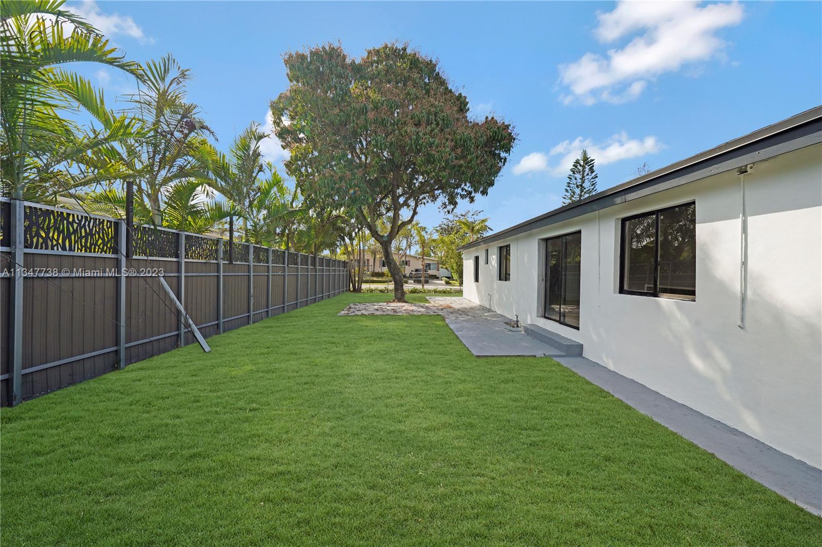 7950 Southwest 22nd Street Miami, FL 33155 - Photo 33 of 36 a view of a backyard with potted plants and a large tree