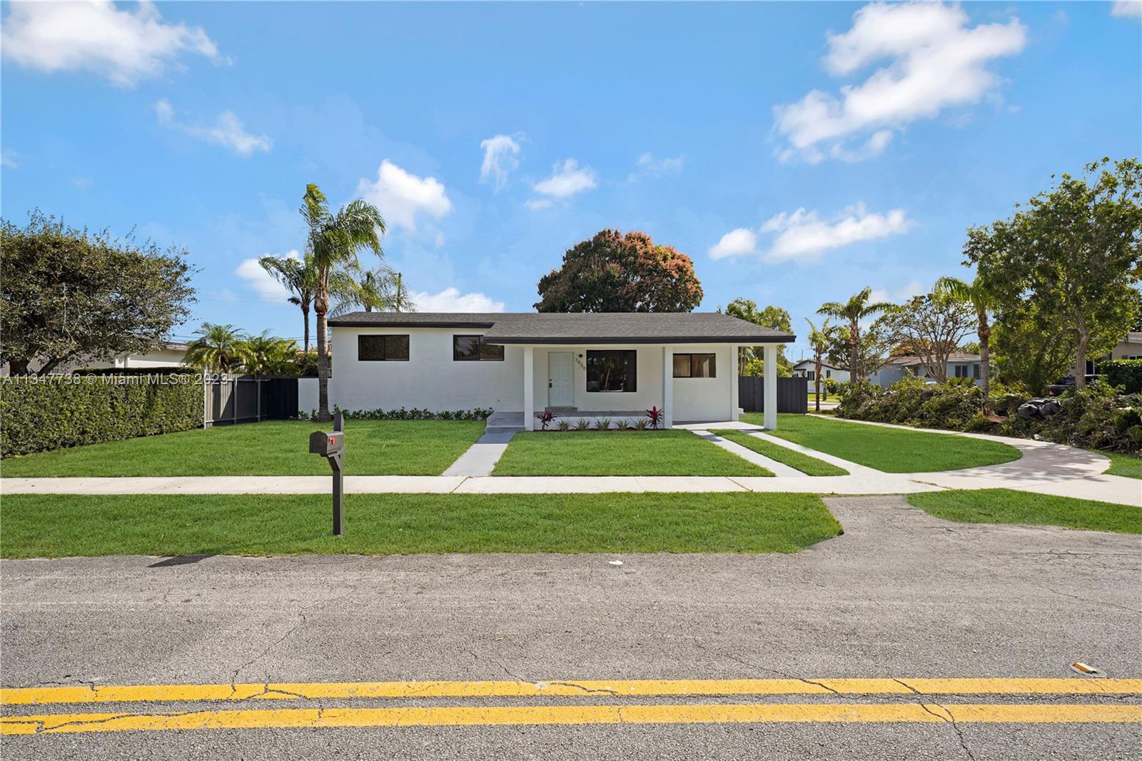 7950 Southwest 22nd Street Miami, FL 33155 - Photo 36 of 36 a view of a white house with a swimming pool and a yard