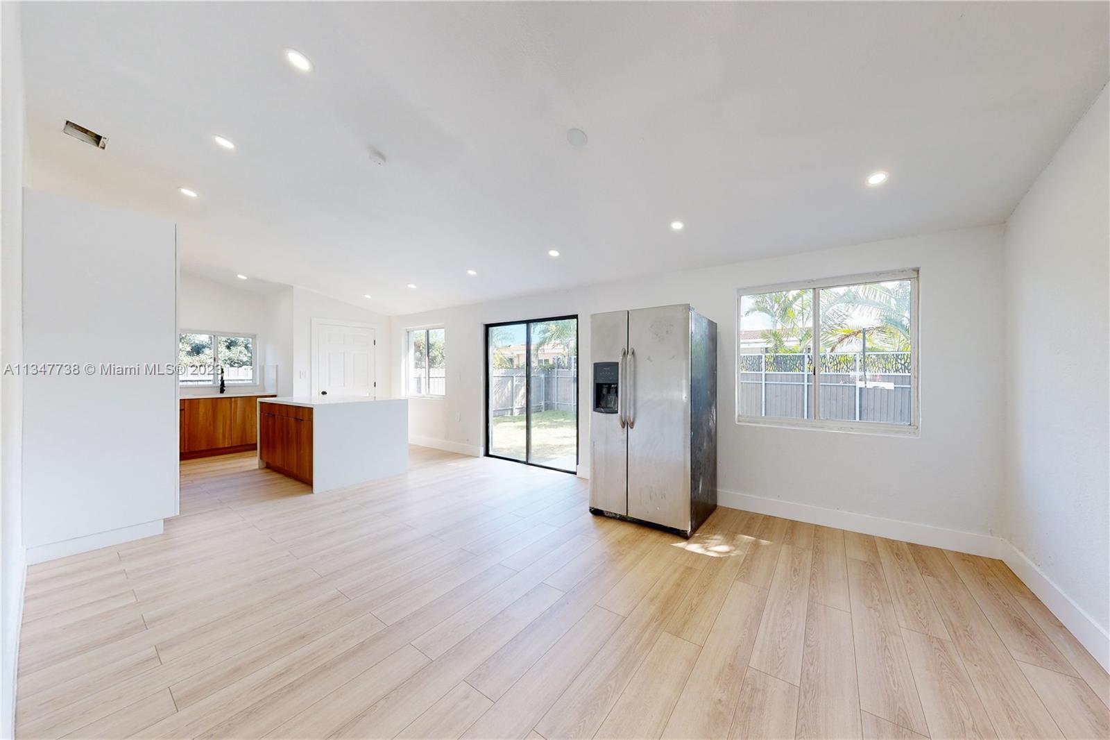 7950 Southwest 22nd Street Miami, FL 33155 - Photo 5 of 36 a view of a big room with wooden floor and windows