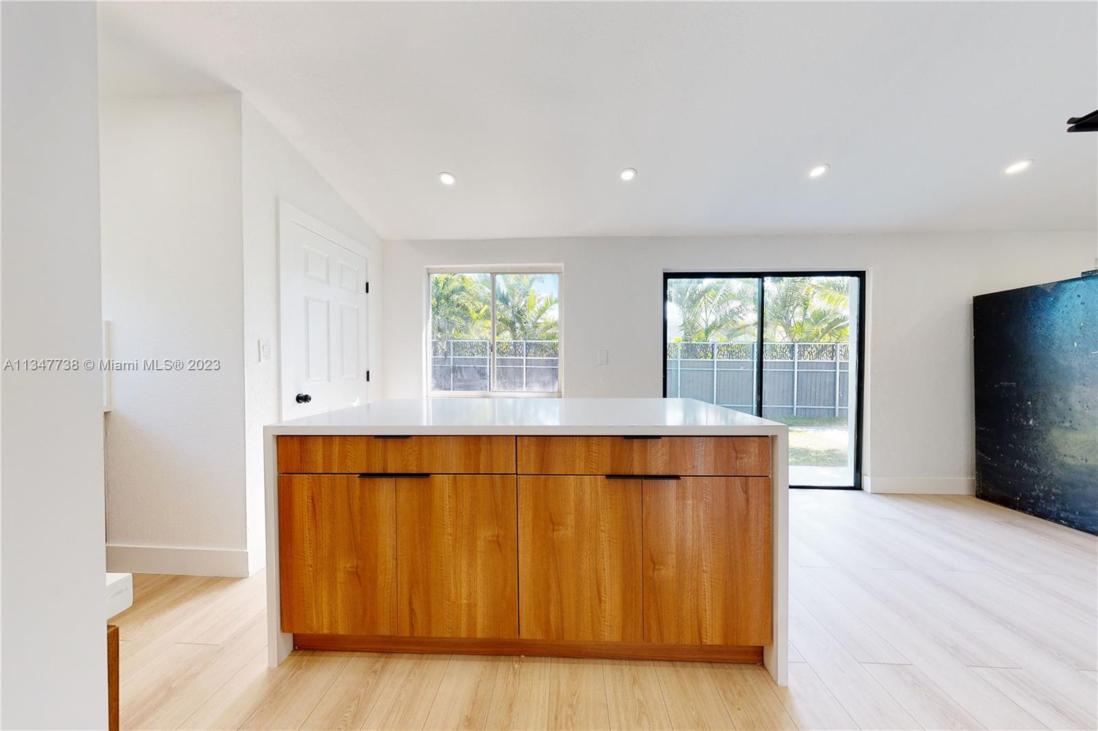 7950 Southwest 22nd Street Miami, FL 33155 - Photo 10 of 36 an empty room with wooden floor and windows