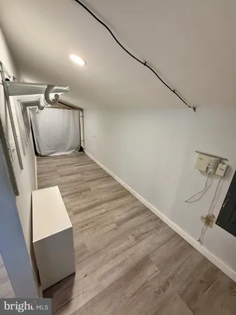 a view of an empty room with wooden floor