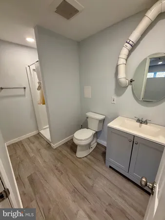 a bathroom with a sink mirror vanity and toilet