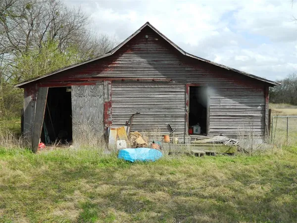 a view of a field with an trees