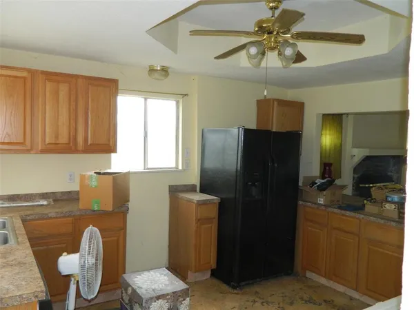 a kitchen with stainless steel appliances granite countertop a refrigerator a stove a sink and dishwasher