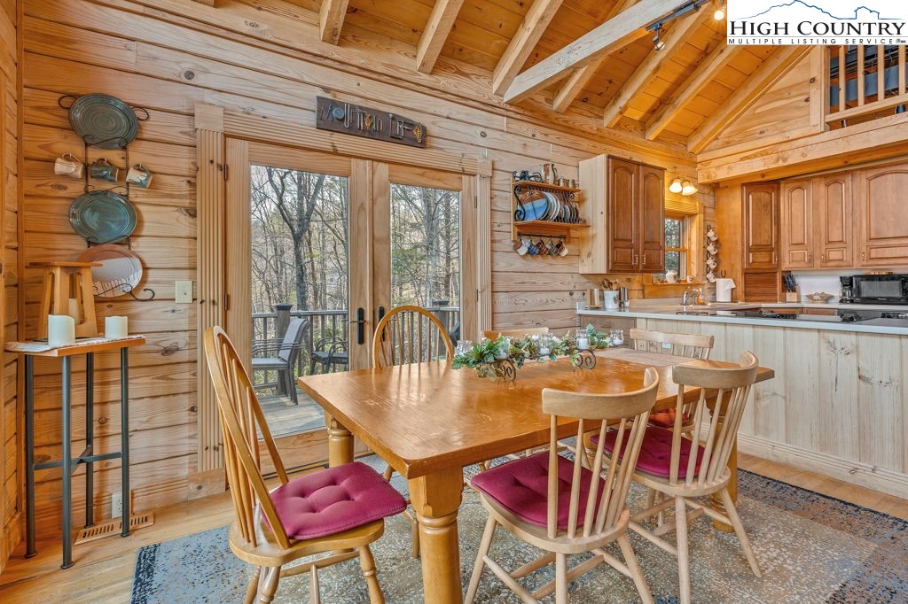 801 Wagon Ridge Road Ferguson, NC 28624 - Photo 18 of 44 a dining room with furniture a chandelier and wooden floor