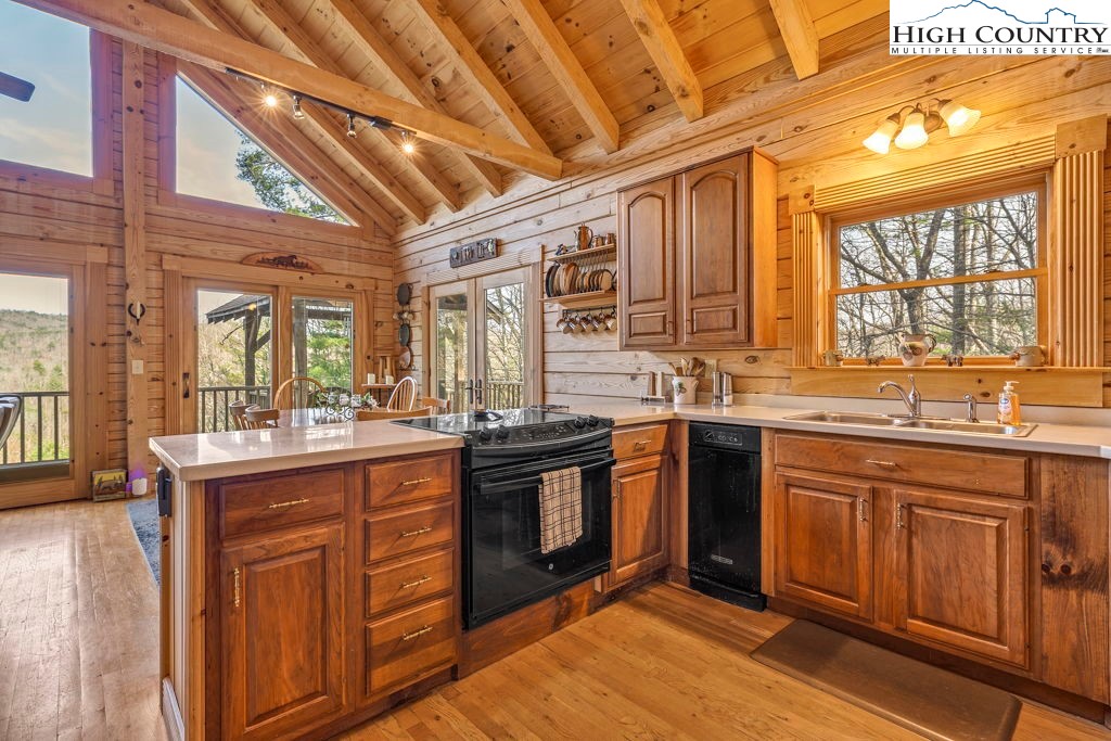 801 Wagon Ridge Road Ferguson, NC 28624 - Photo 20 of 44 a kitchen with granite countertop stainless steel appliances and wooden cabinets