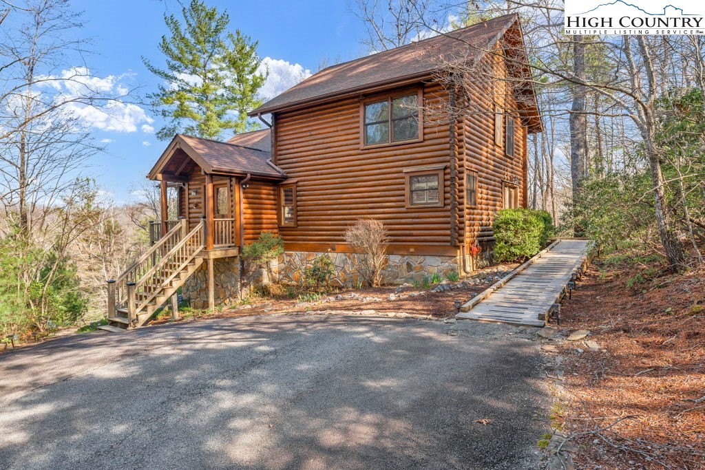 801 Wagon Ridge Road Ferguson, NC 28624 - Photo 2 of 44 a view of a house with a yard and potted plants