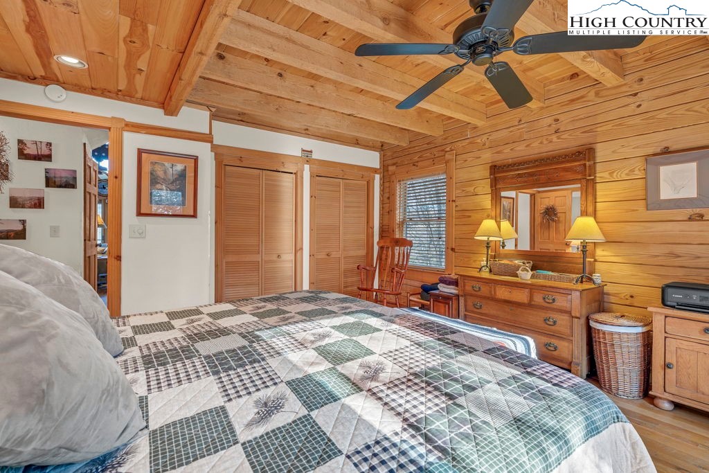 801 Wagon Ridge Road Ferguson, NC 28624 - Photo 23 of 44 a bedroom with a bed and wooden floor