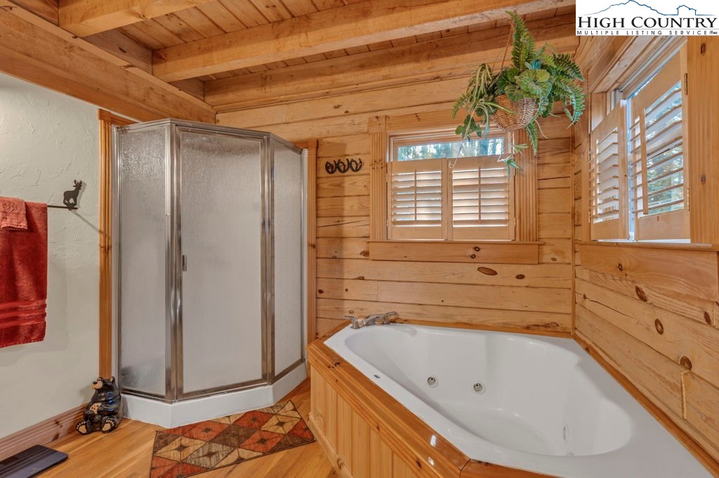 801 Wagon Ridge Road Ferguson, NC 28624 - Photo 25 of 44 a bathroom with a bathtub and a shower