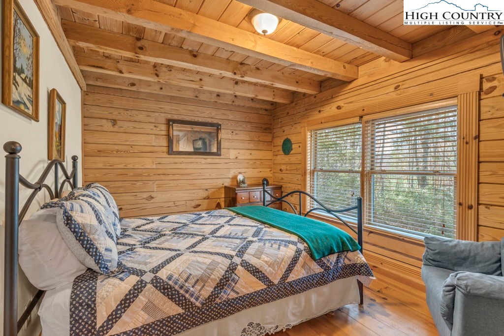 801 Wagon Ridge Road Ferguson, NC 28624 - Photo 33 of 44 a bed sitting in a bedroom next to a window