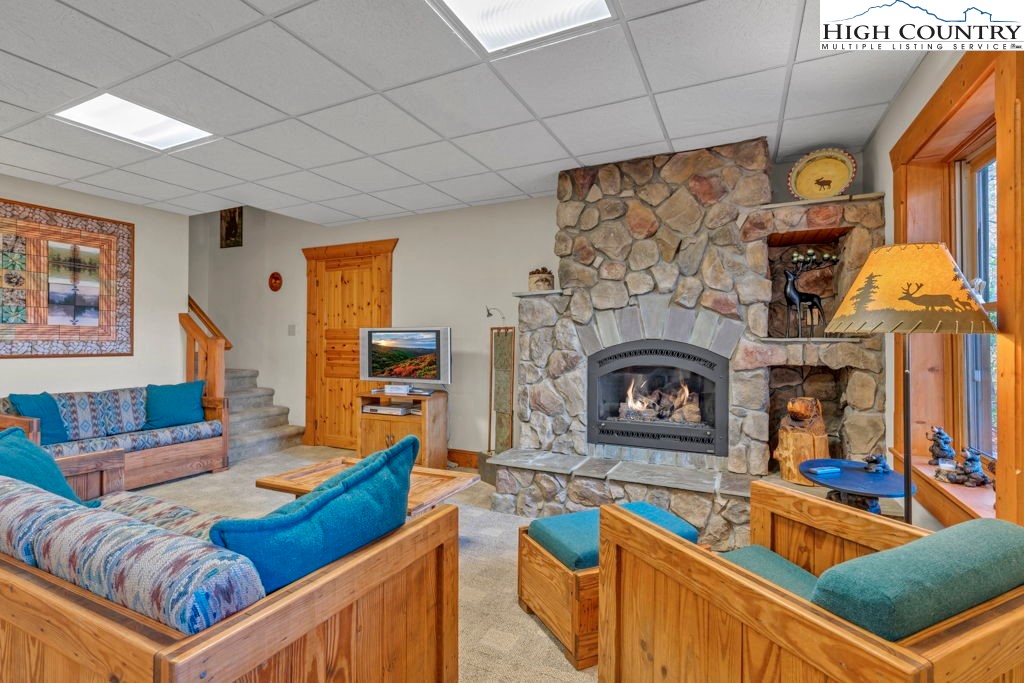 801 Wagon Ridge Road Ferguson, NC 28624 - Photo 37 of 44 a living room with furniture and a fireplace