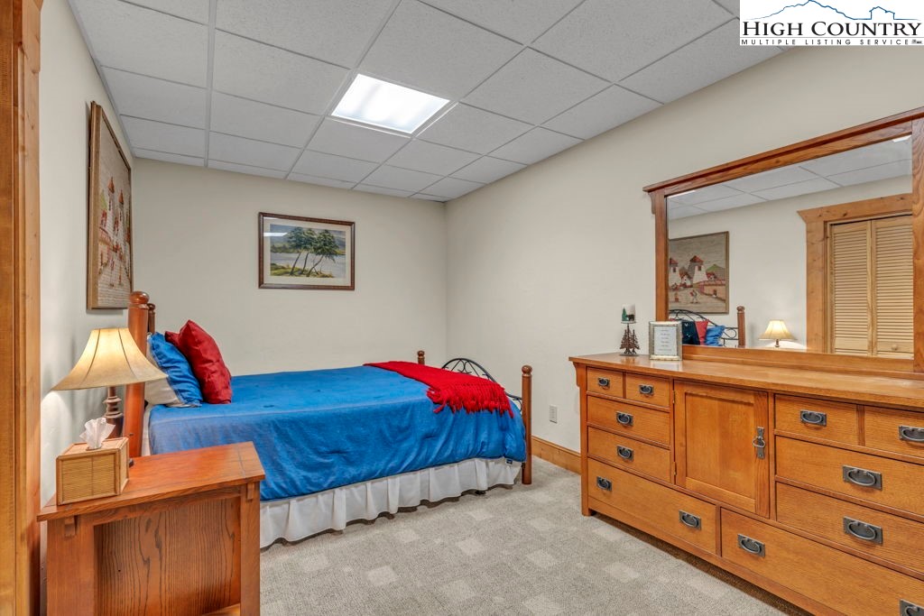 801 Wagon Ridge Road Ferguson, NC 28624 - Photo 40 of 44 a bedroom with a bed and a dresser in it