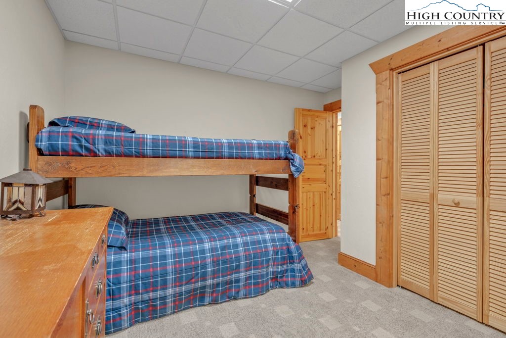 801 Wagon Ridge Road Ferguson, NC 28624 - Photo 42 of 44 a bedroom with a bed and wooden floor