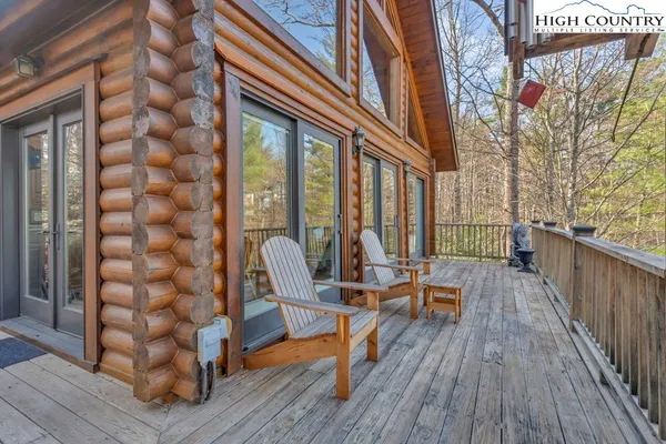 a view of a balcony with chairs and wooden floor