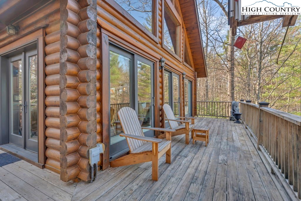 801 Wagon Ridge Road Ferguson, NC 28624 - Photo 10 of 44 a view of a balcony with chairs and wooden floor